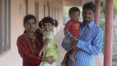 Evangeline, Ashok and their children outside the new Amen Trust orphanage building